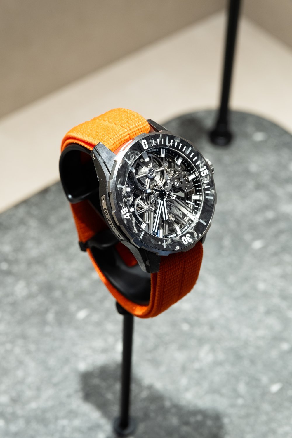 Skeletonised Ulysse Nardin diver on an orange strap
